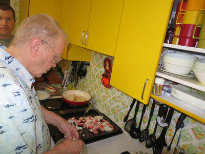 Dad fixing lobster rolls (but with crab)