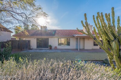 Back of the house facing west. The wood fence to the left is a private cactus garden for the tub in the primary bathroom.