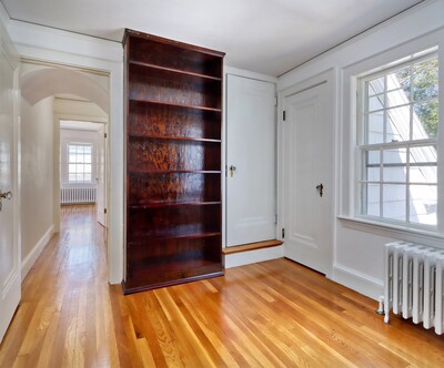 Bedroom 5, Don's old office. The door to the right is a closet. The door with the step goes to the attic.