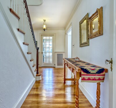 Looking from the top of the basement stairs to the front door.