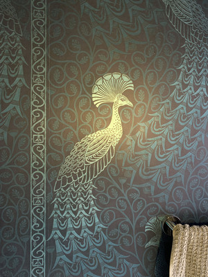 The downstairs bathroom had green metallic wallpaper with peacocks