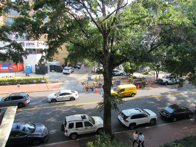 City workers laying sidewalk bricks across the street. 1:20PM 9/8/2023